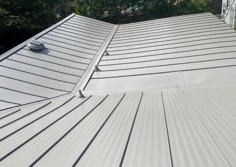 Solar attic fan installed on a metal roof for Roof Ventilation in Milledgeville